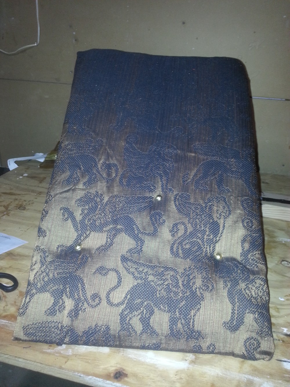 Putting in upholstery tacks.