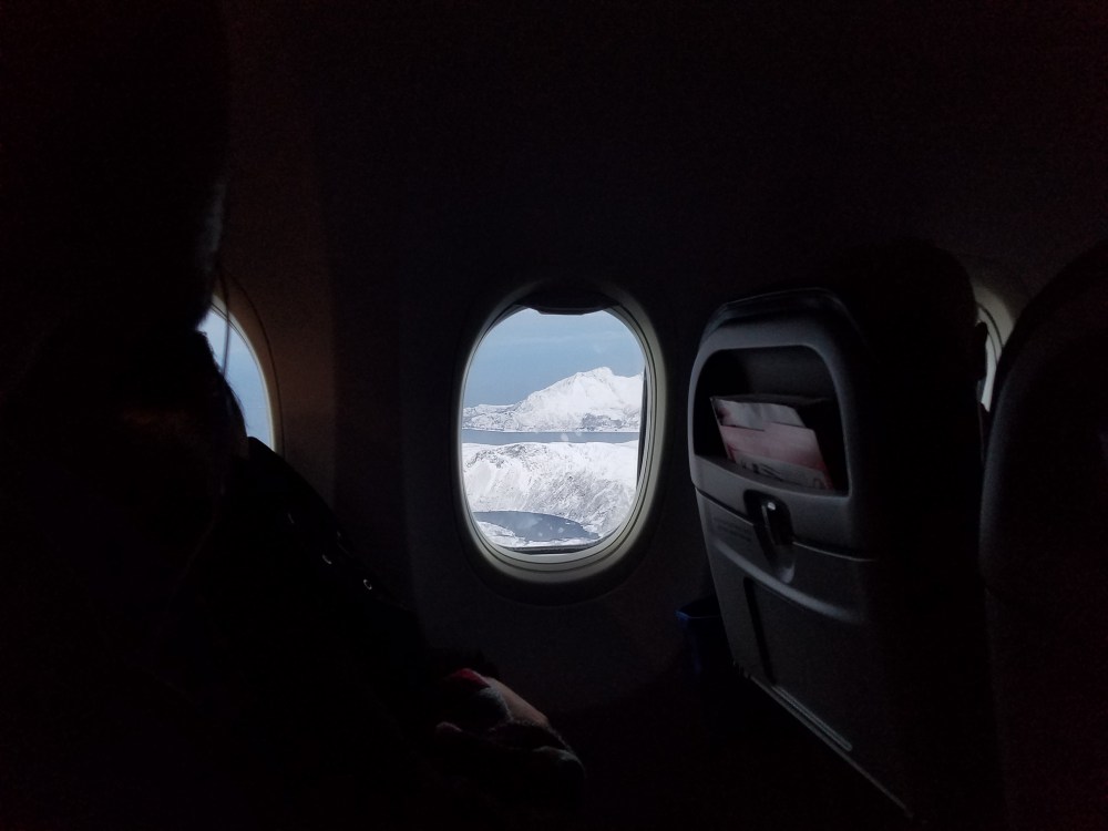Flying from Oslo to Tromso, Norway - the moment the white sky opened on white mountains. November, 2016